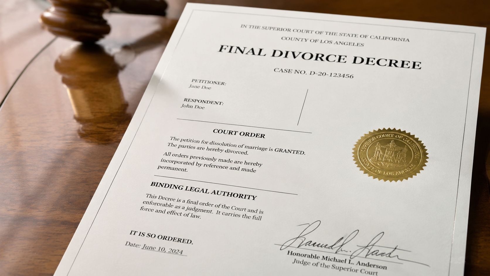 A close-up view of a final divorce decree document on a wooden table beside a judge's gavel.